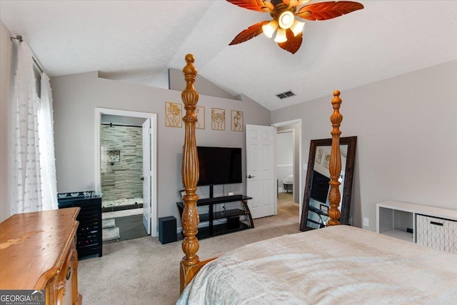 bedroom featuring ceiling fan, light colored carpet, lofted ceiling, and ensuite bath