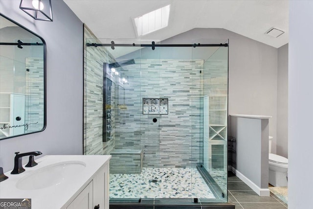 bathroom with lofted ceiling, vanity, toilet, and an enclosed shower