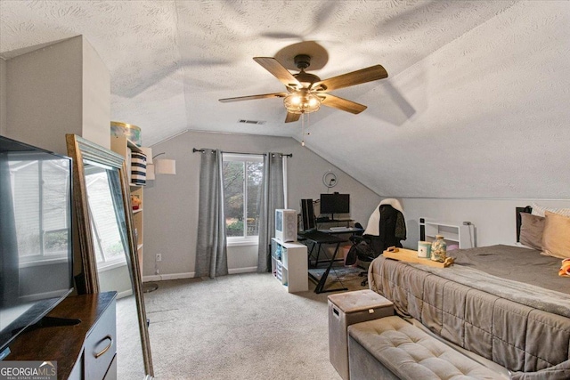 carpeted bedroom with lofted ceiling, ceiling fan, and a textured ceiling