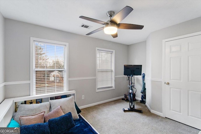 exercise room featuring carpet flooring and ceiling fan