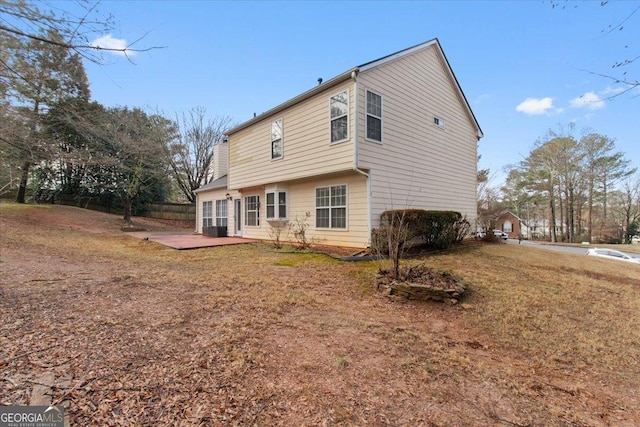 back of property featuring a lawn and a patio