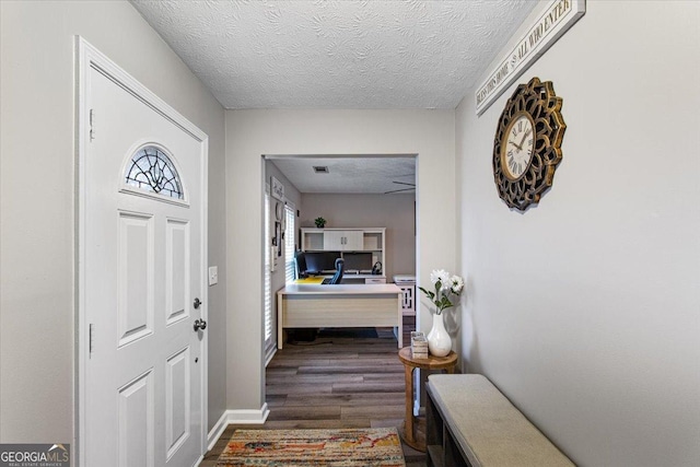 entryway featuring dark hardwood / wood-style floors and a textured ceiling