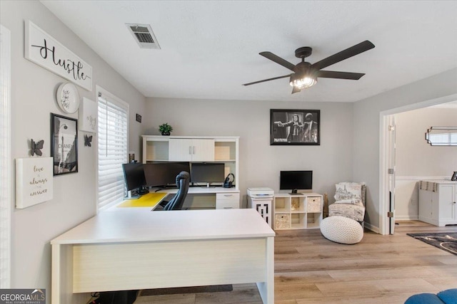 home office featuring ceiling fan and light hardwood / wood-style floors