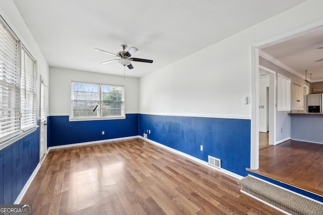 spare room featuring hardwood / wood-style flooring and ceiling fan