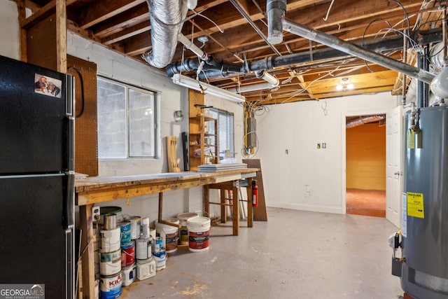 basement featuring black refrigerator and gas water heater