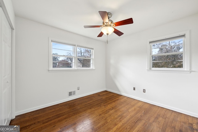 unfurnished bedroom with hardwood / wood-style flooring, a closet, and ceiling fan