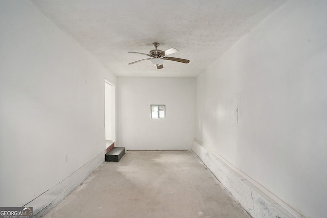 spare room with ceiling fan and a textured ceiling