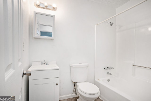 full bathroom featuring vanity, toilet,  shower combination, and a textured ceiling