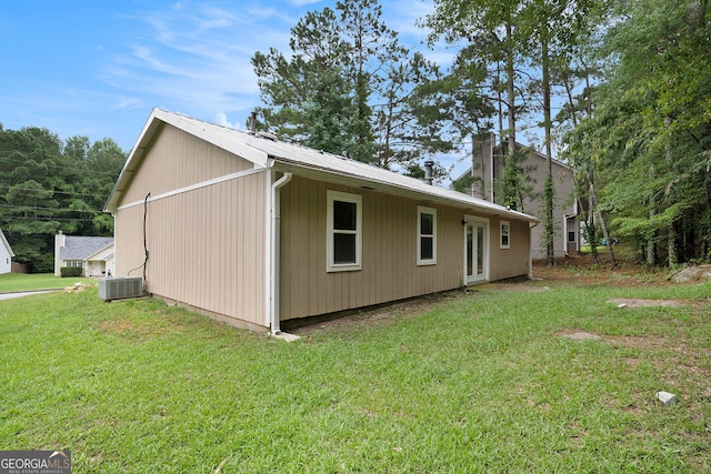 view of property exterior featuring cooling unit and a lawn