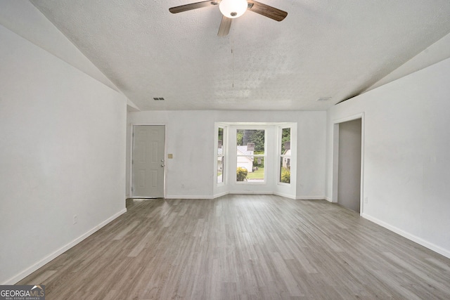 empty room featuring hardwood / wood-style flooring, ceiling fan, and a textured ceiling