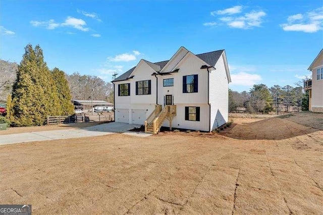 view of front of house featuring a garage and a front lawn