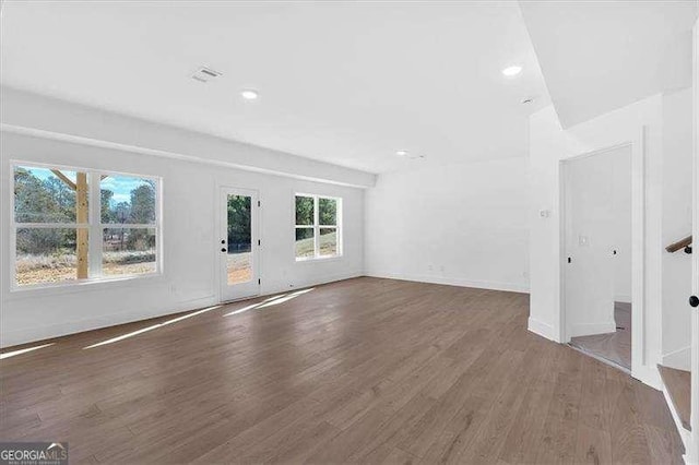 unfurnished living room with dark hardwood / wood-style floors