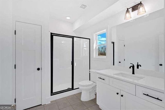 bathroom with walk in shower, tile patterned floors, toilet, and vanity