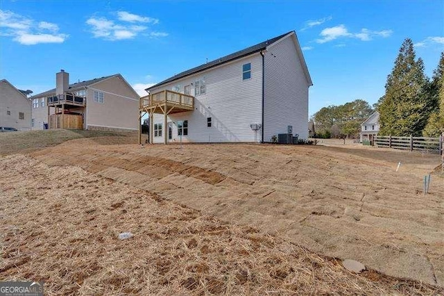 back of property with a wooden deck and central air condition unit