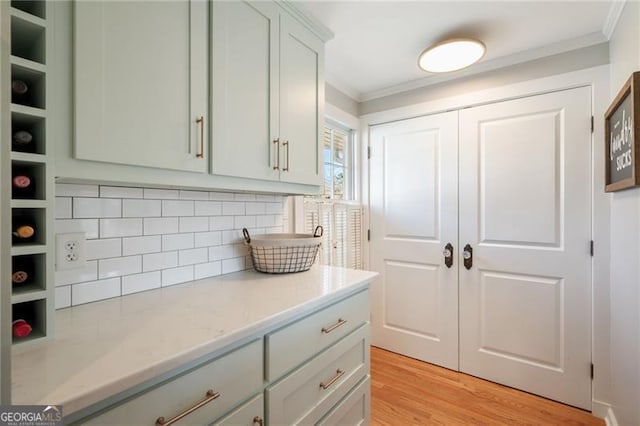 kitchen featuring open shelves, ornamental molding, backsplash, and light wood-style floors