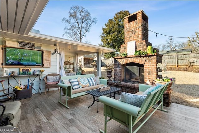 wooden deck with an outdoor living space with a fireplace and fence