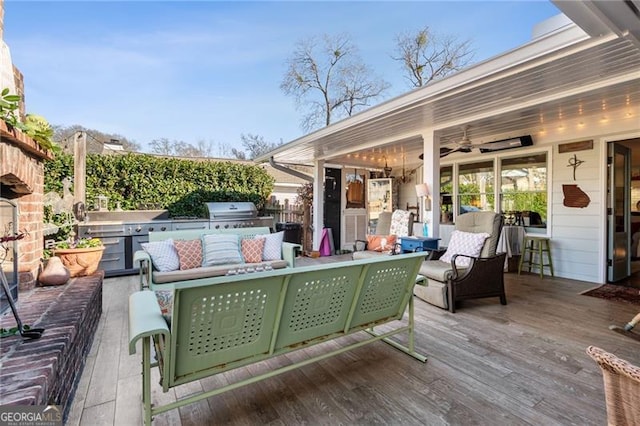 view of patio / terrace featuring area for grilling, an outdoor hangout area, a grill, fence, and a wooden deck