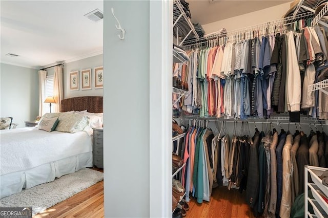 spacious closet with wood finished floors and visible vents