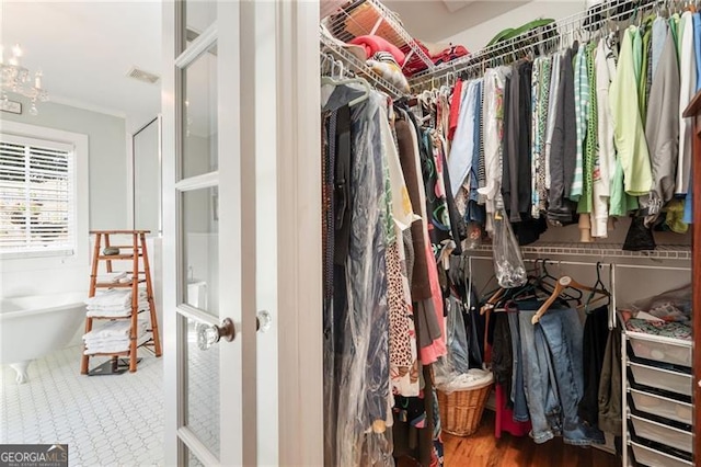 walk in closet featuring french doors and visible vents