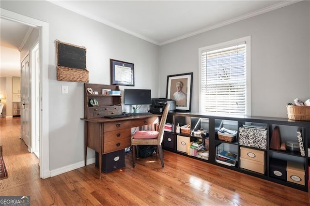 office area featuring ornamental molding, baseboards, and wood finished floors