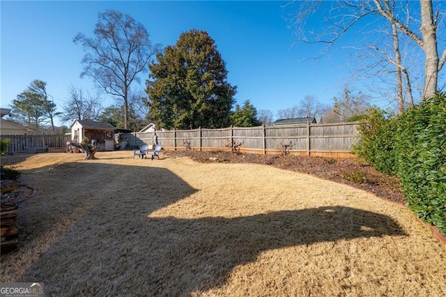 view of yard featuring an outdoor structure and a fenced backyard