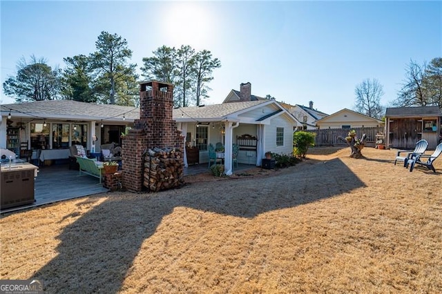 rear view of house with a patio area, fence, and a lawn