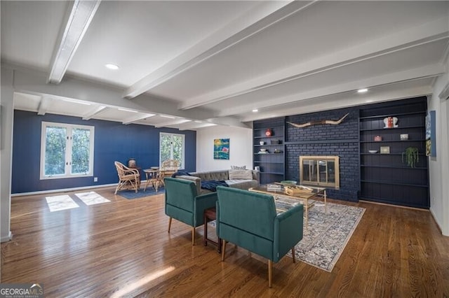 living room featuring hardwood / wood-style floors, beamed ceiling, and a healthy amount of sunlight