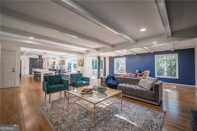 living room with beamed ceiling and hardwood / wood-style flooring