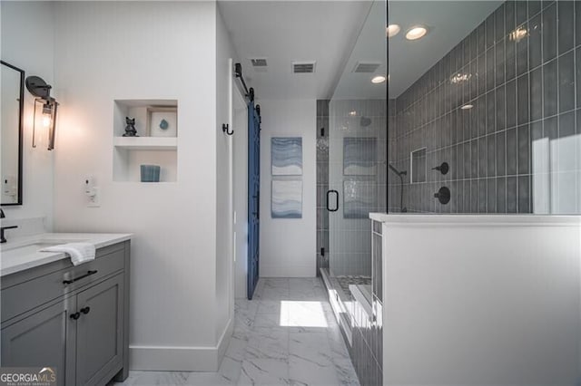 bathroom with vanity and a shower with door