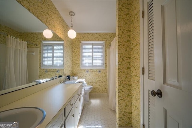 bathroom with tile patterned floors, vanity, and toilet