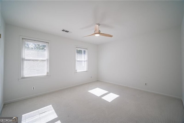 empty room with light colored carpet and ceiling fan