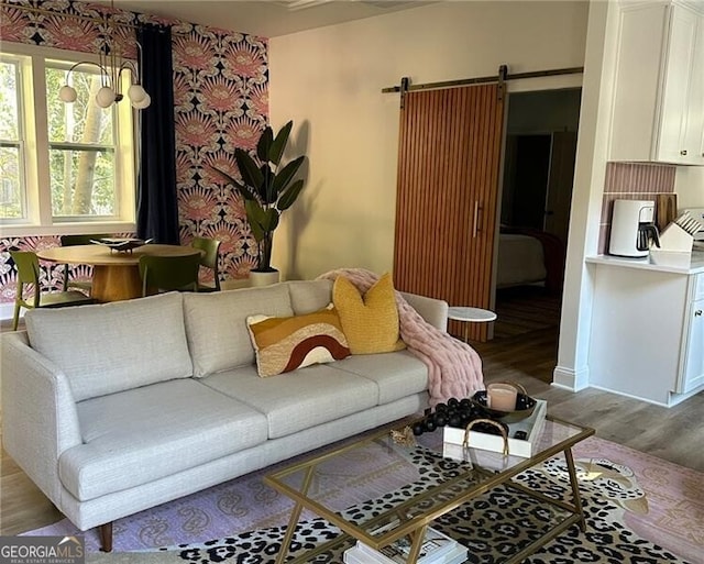 living room featuring a barn door and hardwood / wood-style floors