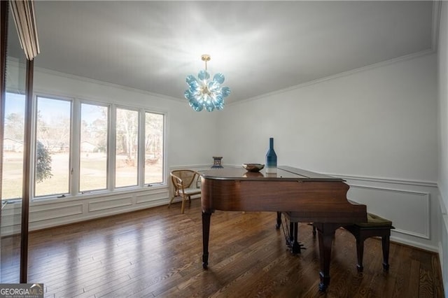 misc room with an inviting chandelier, ornamental molding, and dark hardwood / wood-style flooring