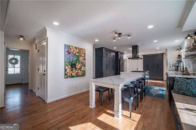 dining area with sink, ornamental molding, and dark hardwood / wood-style floors