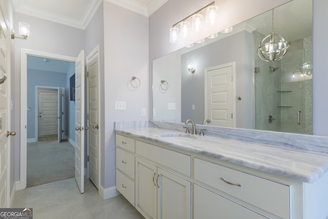 bathroom with ornamental molding, an enclosed shower, and vanity