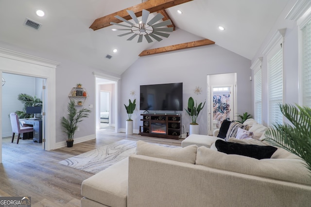 living room featuring beamed ceiling, ceiling fan, high vaulted ceiling, and light wood-type flooring