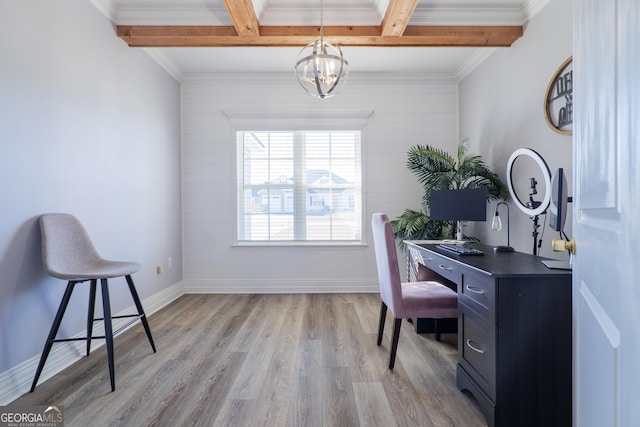 office with beam ceiling, coffered ceiling, a notable chandelier, ornamental molding, and light hardwood / wood-style floors