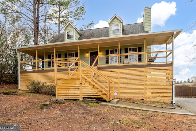 new england style home with a porch