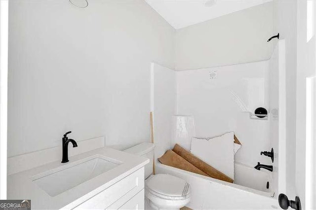 full bathroom featuring vanity, bathing tub / shower combination, and toilet