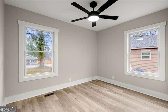 empty room with ceiling fan and light hardwood / wood-style floors