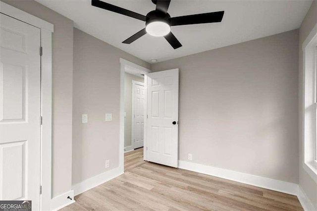 unfurnished bedroom featuring light wood-type flooring and ceiling fan