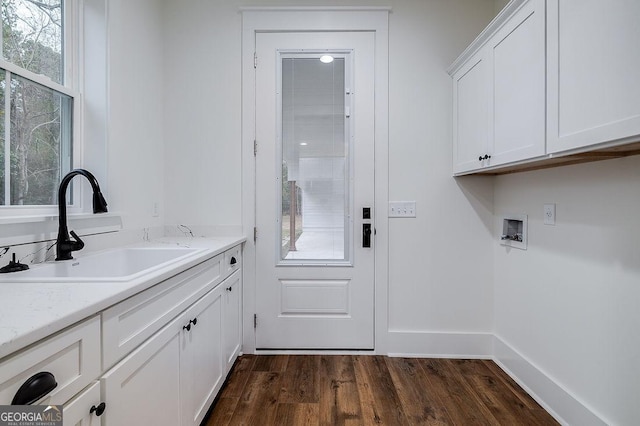 clothes washing area with dark hardwood / wood-style floors, a wealth of natural light, sink, cabinets, and hookup for a washing machine