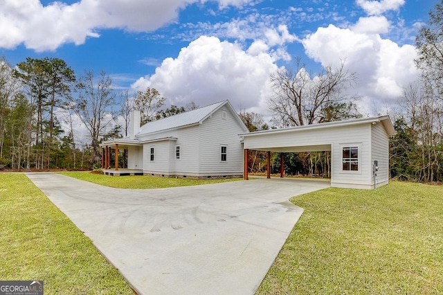 view of side of property featuring a yard and a carport