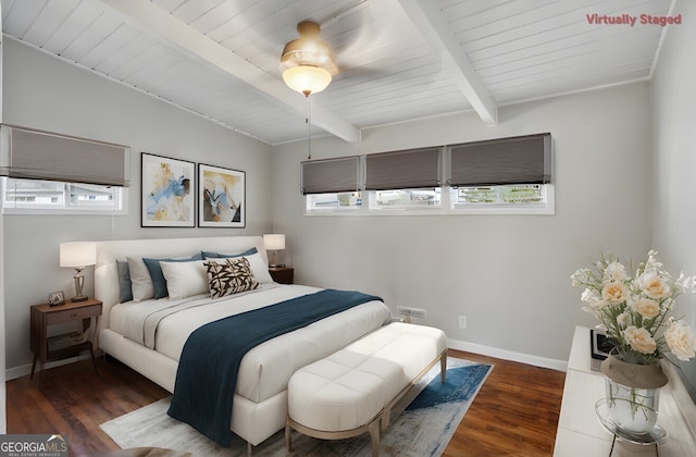 bedroom featuring beamed ceiling, dark wood-type flooring, and wooden ceiling