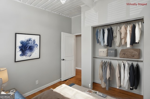 bedroom with light wood-type flooring and a closet