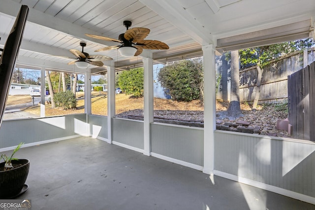 unfurnished sunroom featuring ceiling fan