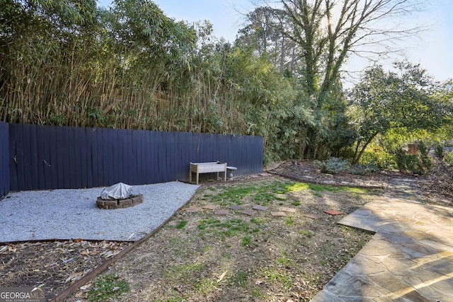 view of yard with a patio and a fire pit