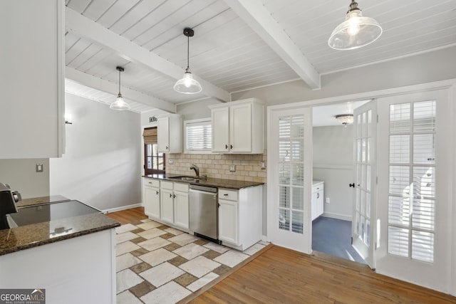 kitchen with hanging light fixtures, white cabinetry, sink, and stainless steel dishwasher