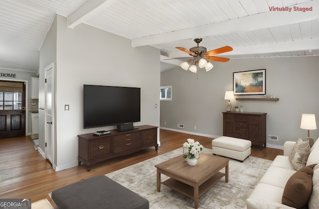 living room featuring light hardwood / wood-style flooring, lofted ceiling with beams, and ceiling fan