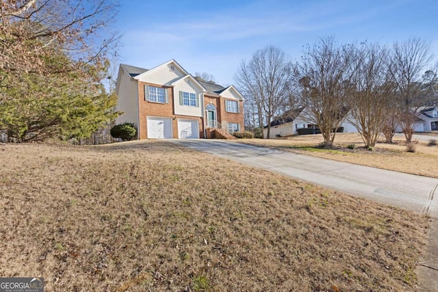 view of front of house with a garage and a front yard